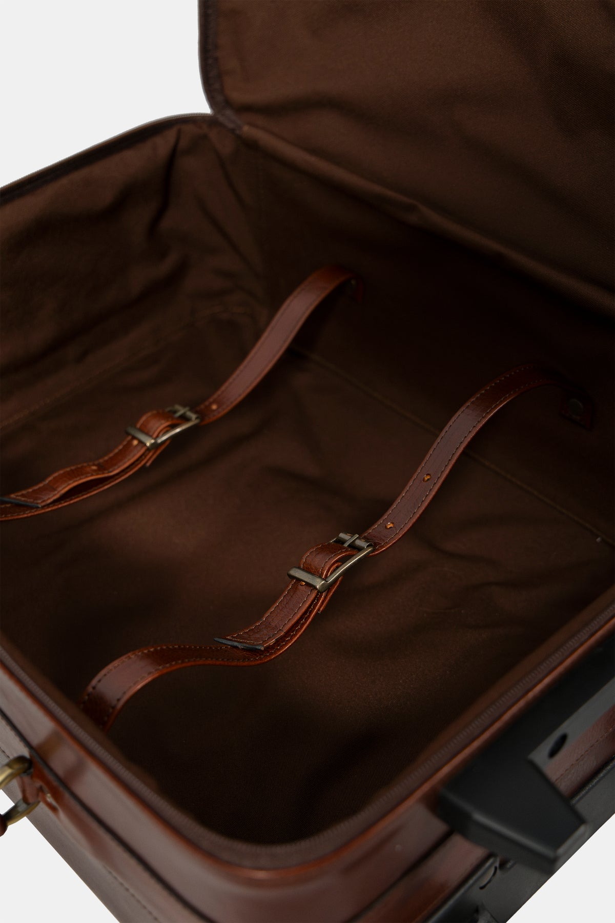 Leather travel trolley in brown, wheel and stitching detail
