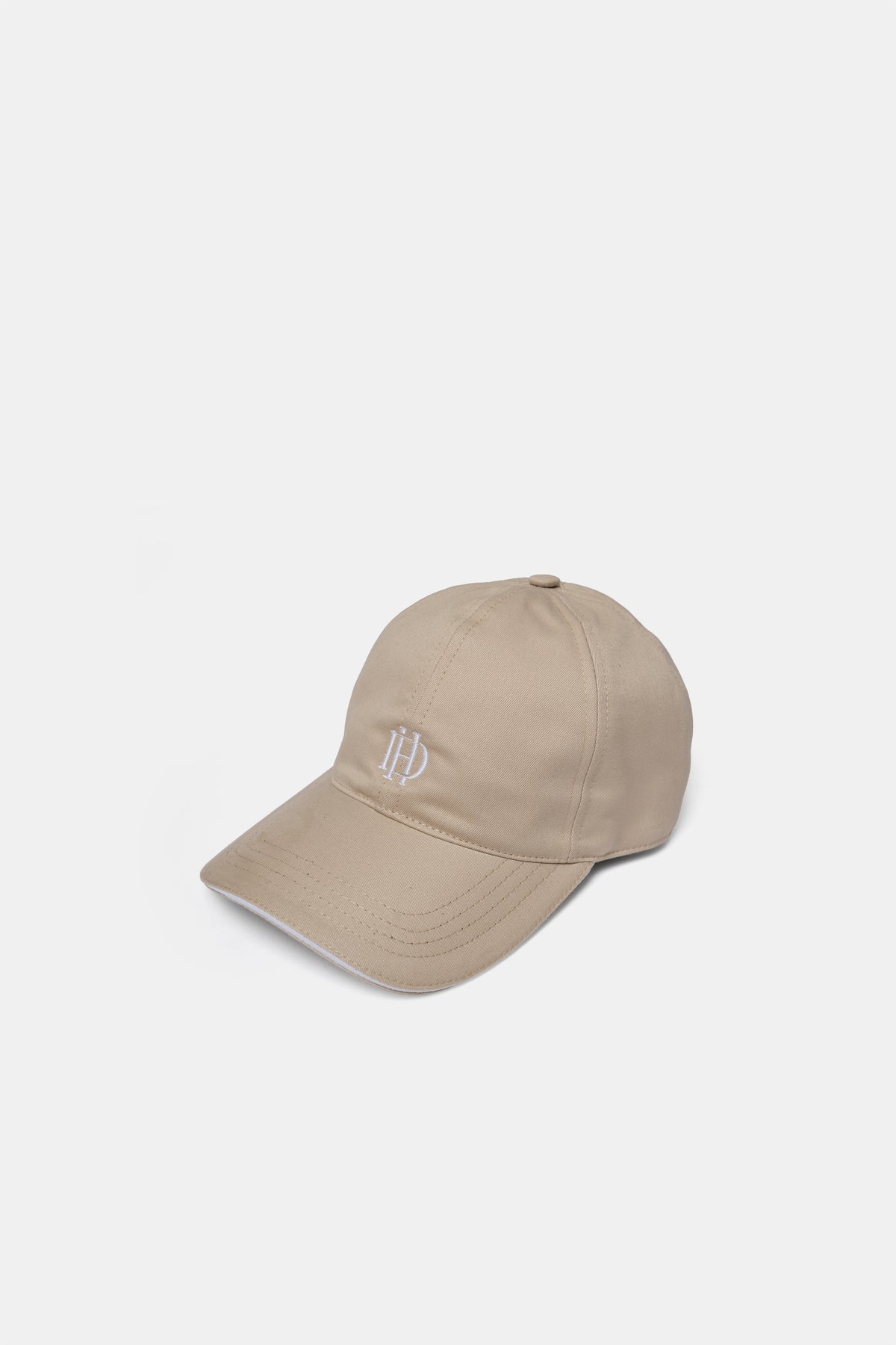 Cotton cap in sand, front view