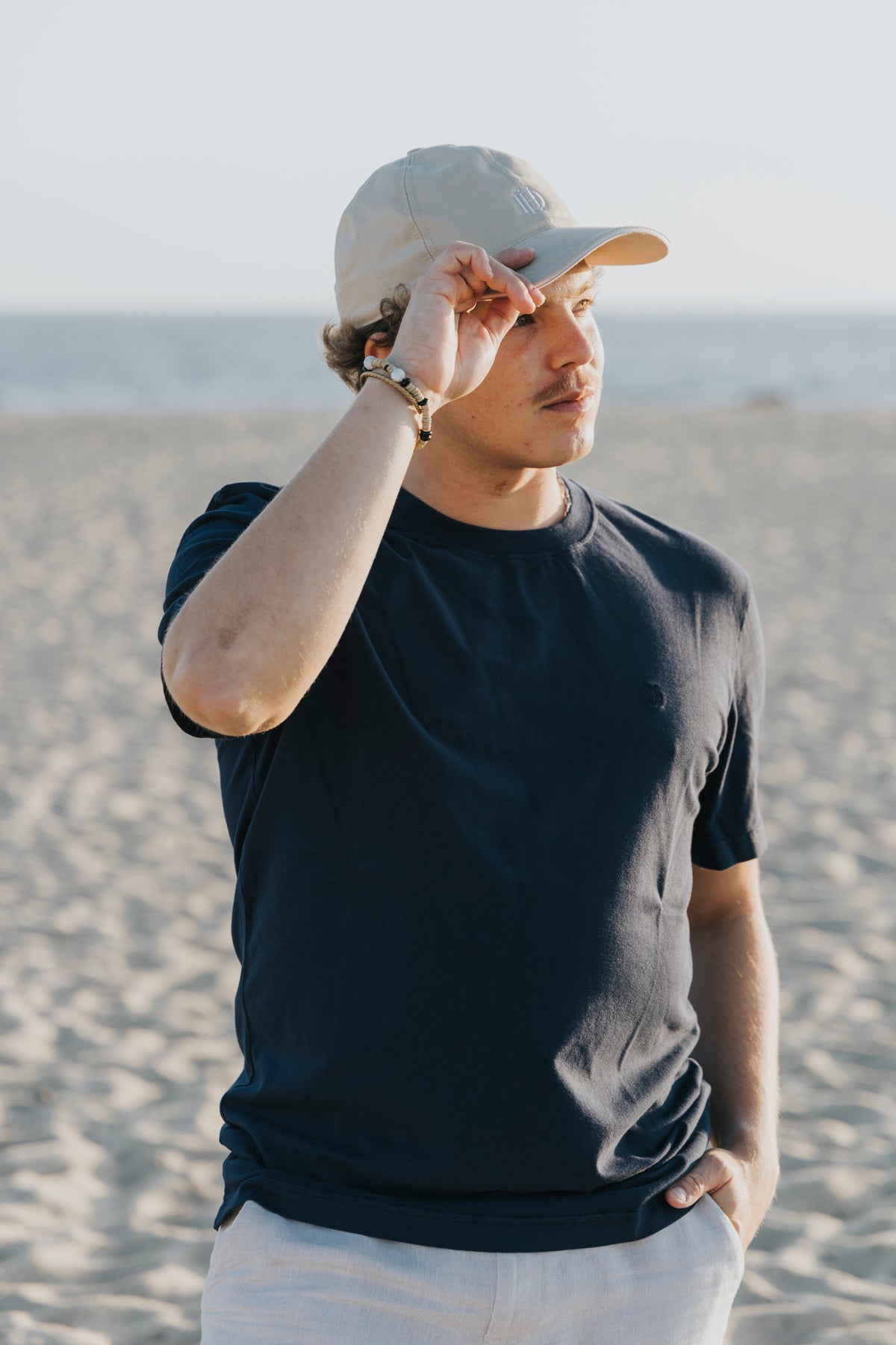 Cotton cap in an outdoor editorial setting, D'Heritage Summer 2026