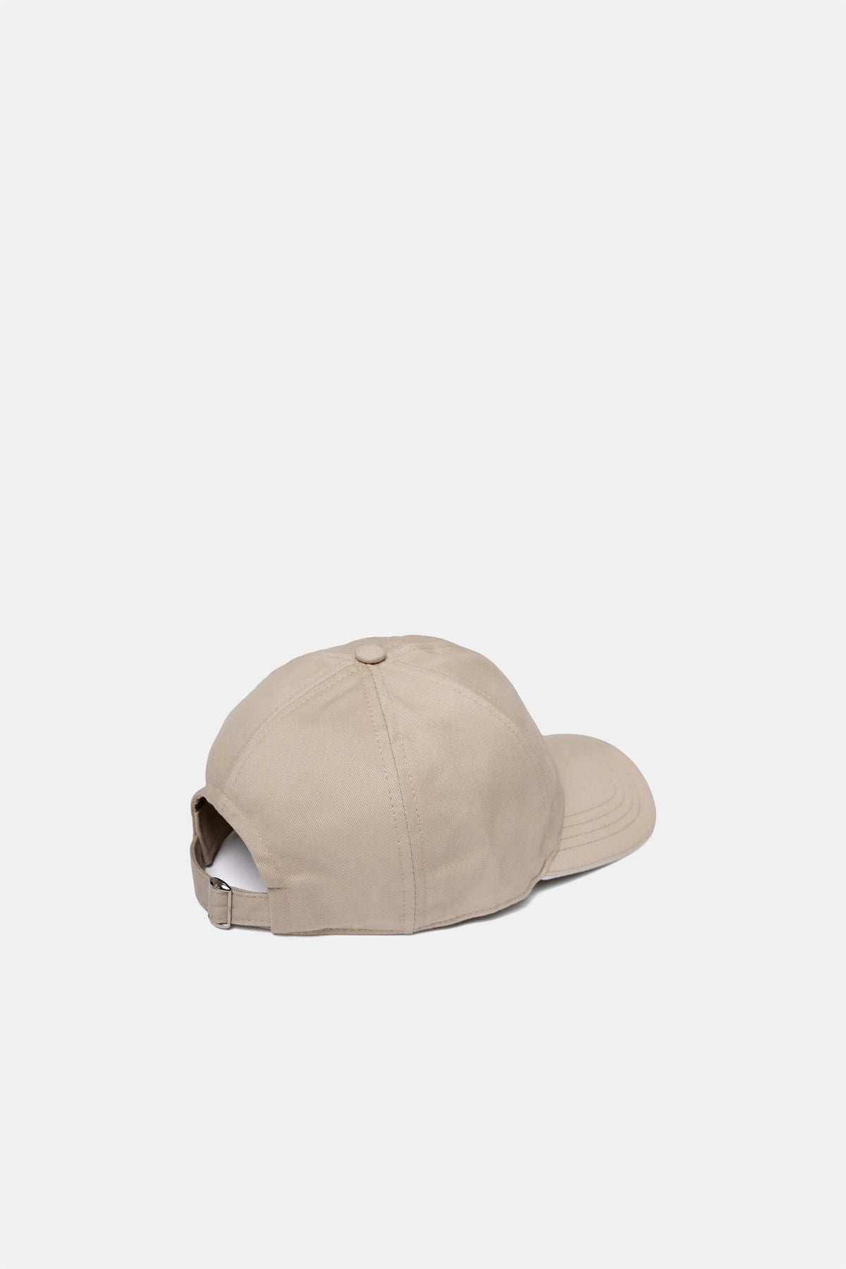Cotton cap in sand, side view