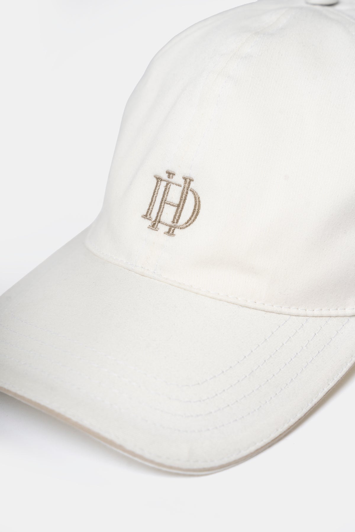 Cotton cap in off-white, back view with adjustable strap