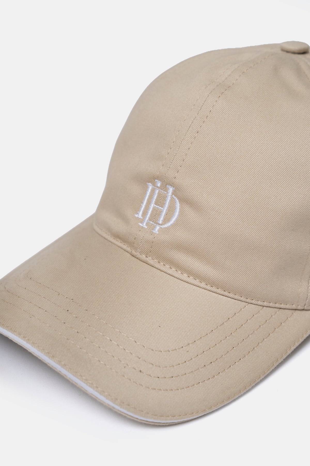 Cotton cap in sand, back view with adjustable strap